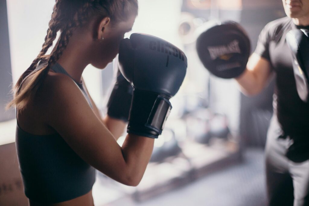 Female shown in a boxing stance, ready for sparring